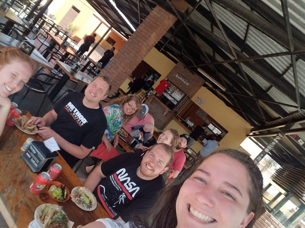 A group of people eating tacos at Tacos El Yaqui in Rosarito Mexico.
