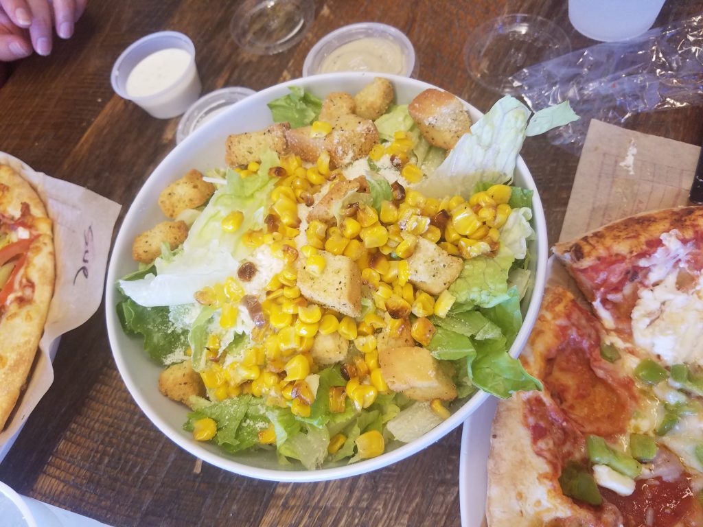 Salad with corn, croutons, lettuce and Caesar dressing at mod pizza