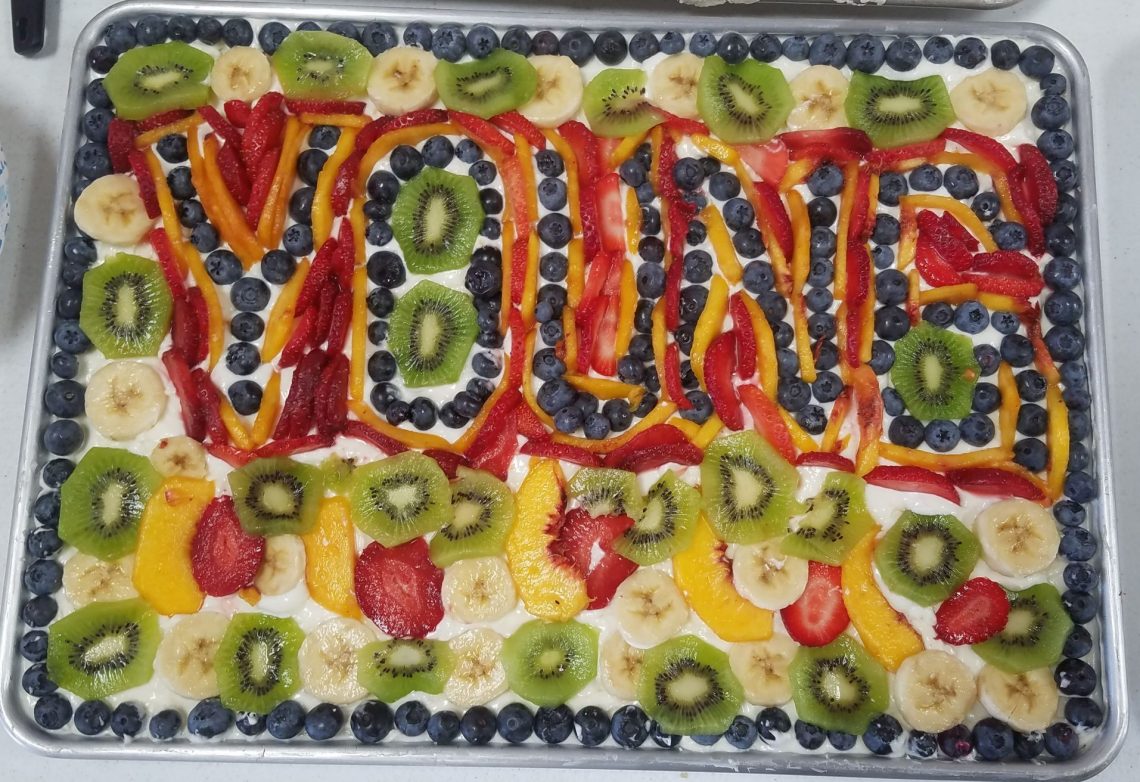 Young spelled in a fruit pizza