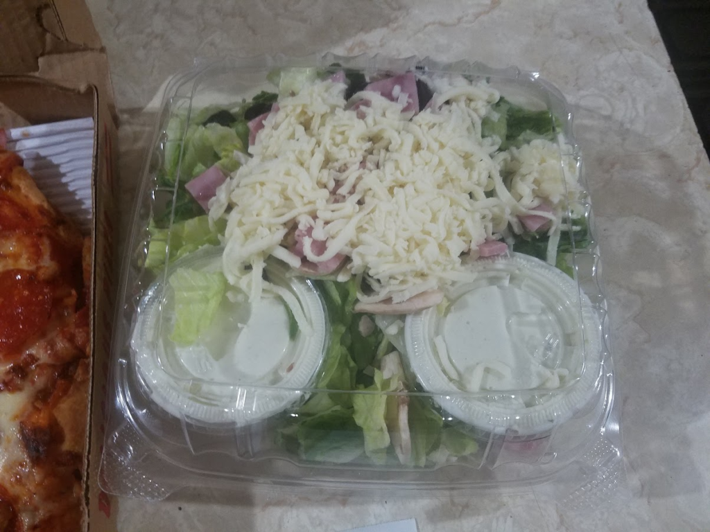  a to-go salad with shredded mozzarella cheese, ham, olives, lettuce and ranch dressing on the side from the Ogden Pizzeria 