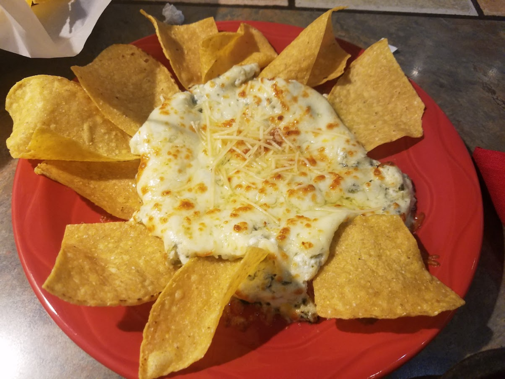 Artichoke chip dip with tortilla chips. 