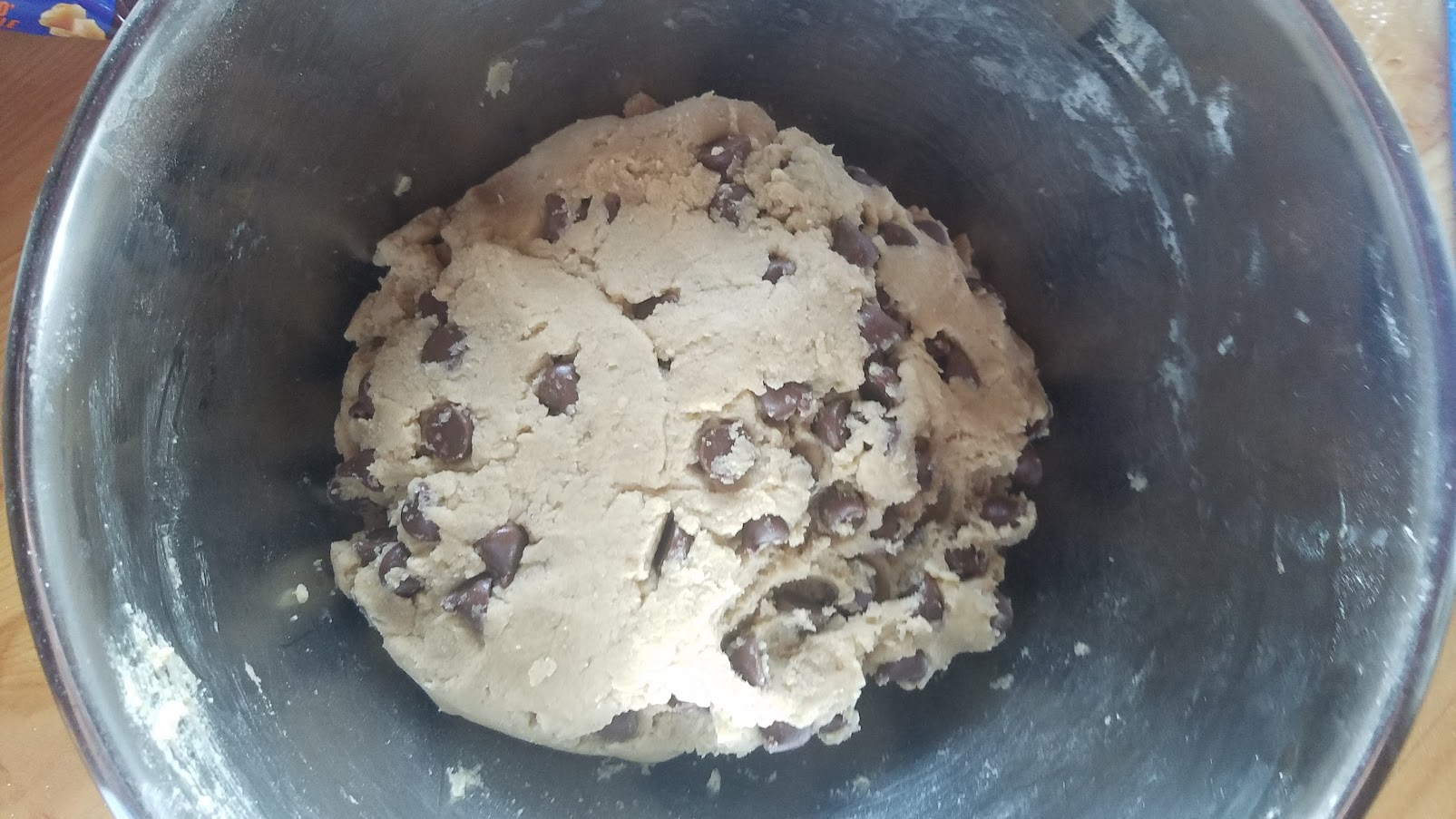 Cookie dough with chocolate chips and health bits in a bowl.