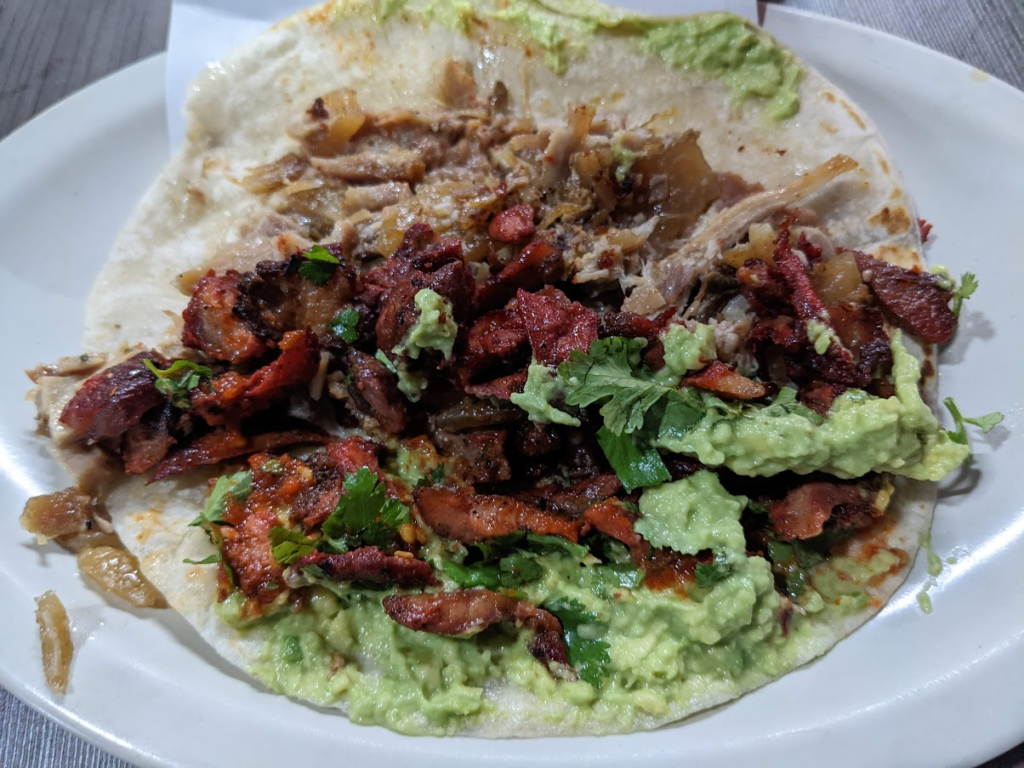 An open burrito with carne asada and al pastor meat with guacamole and cilantro from La Morenitas in Rosarito Mexico