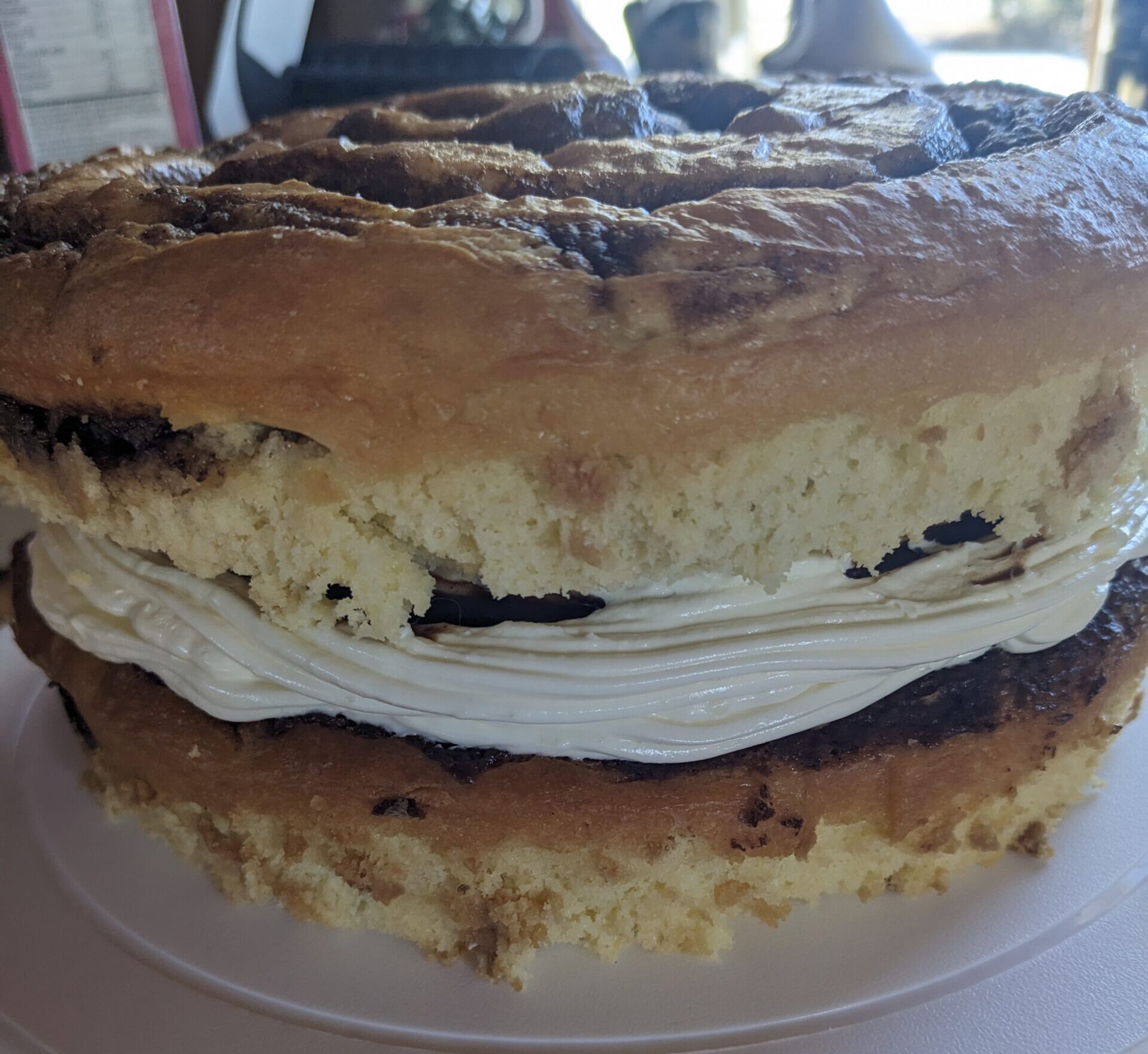 Side view a the cinnamon roll cake without frosting